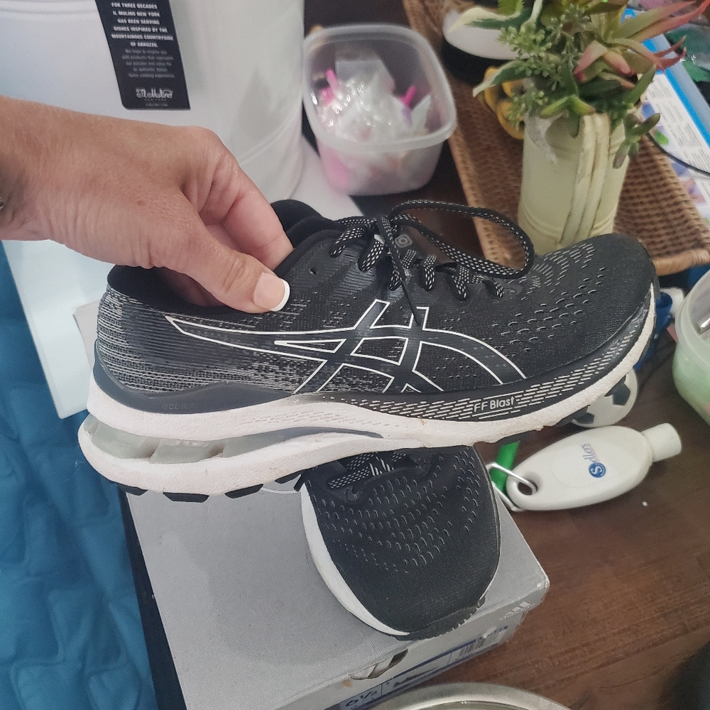 Black and white Asic running shoes
